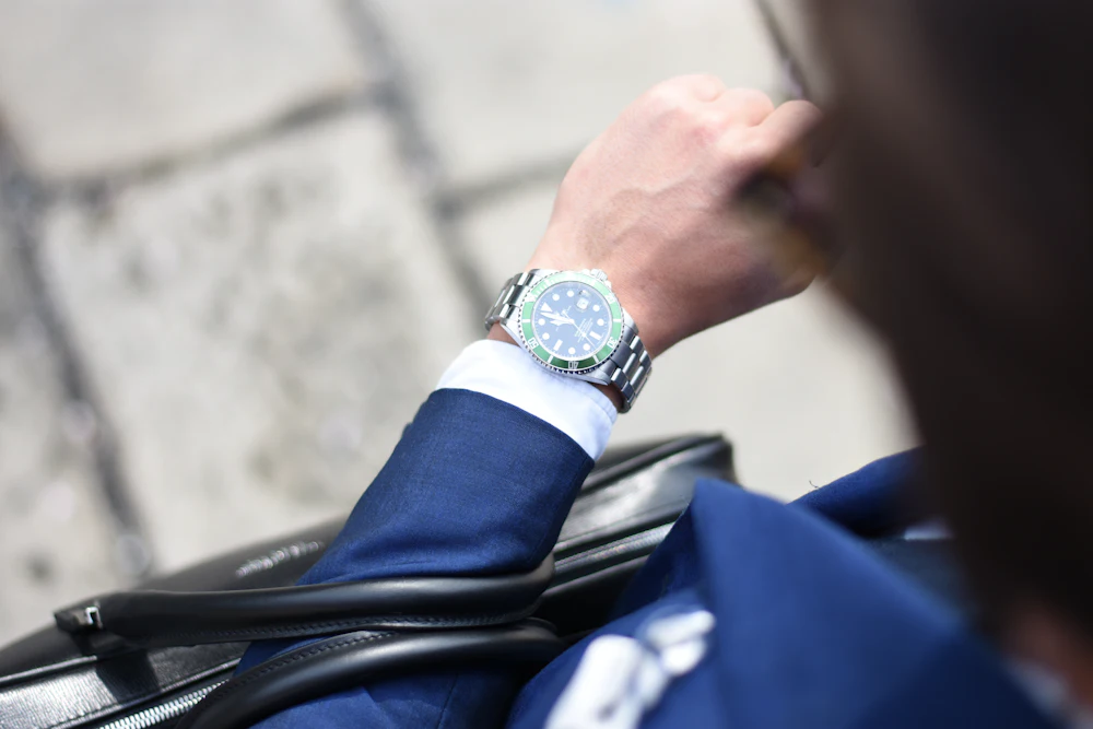Man wearing an analog watch with a suit
