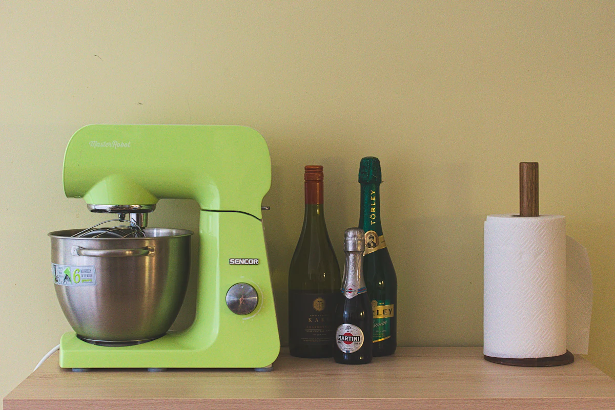 Green stand mixer on a kitchen counter