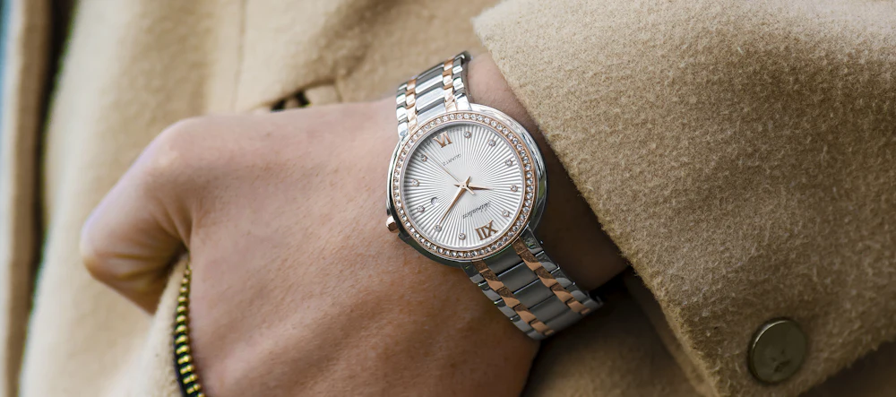 Woman wearing a gold-tone analog watch